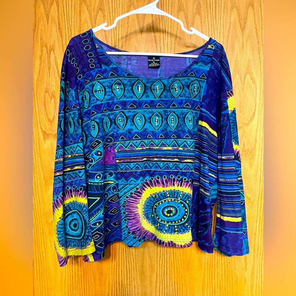 Bold print knit top with sequin detail in front.
